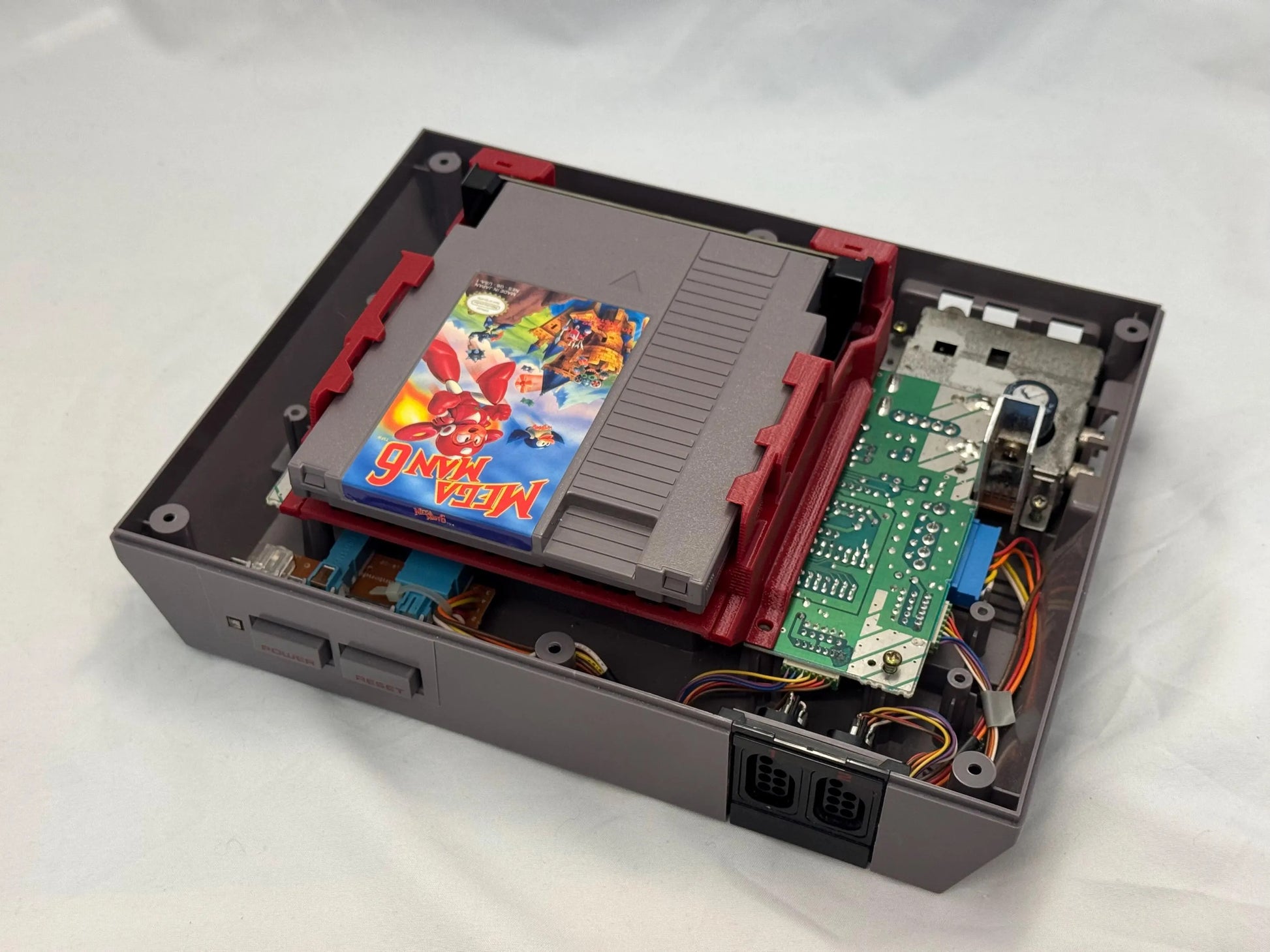 NES cartridge installed in Ninten-Drawer 72-pin connector replacement showing internals of NES