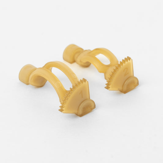 Two translucent gold Renaissance 64 gears, photographed on a clean white background.